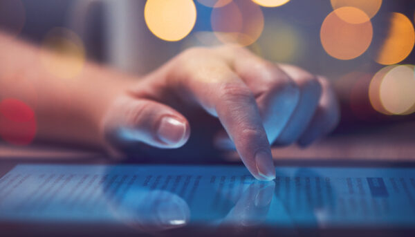 Woman reading online news on digital tablet