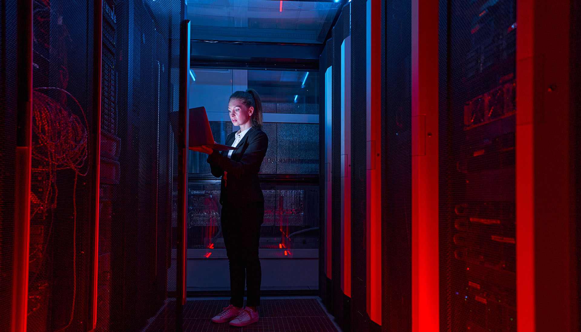 woman working on servers in data centre