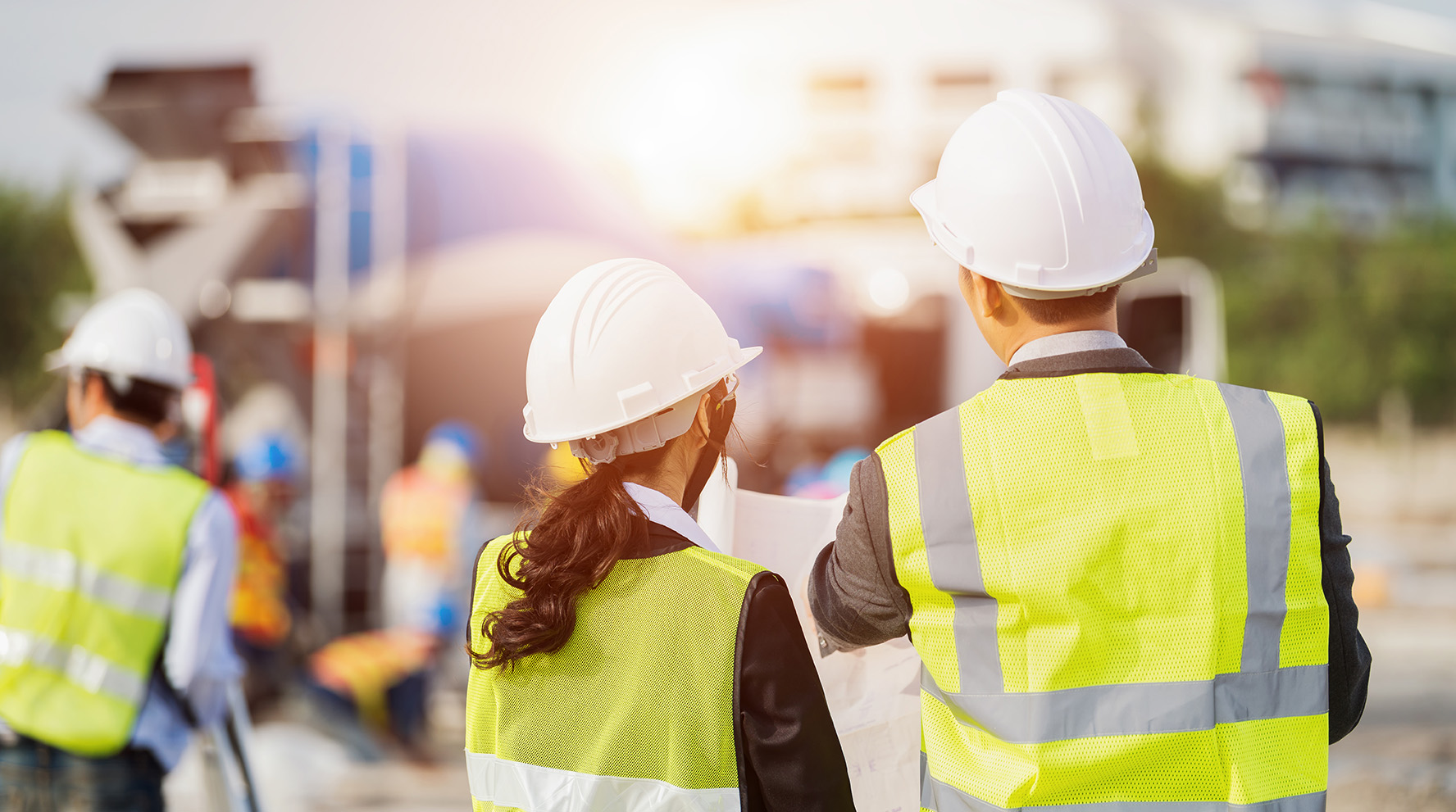 two workers in safety vest at a construction site